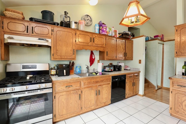 kitchen with pendant lighting, sink, dishwasher, stainless steel range with gas stovetop, and vaulted ceiling