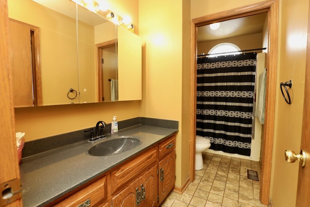 bathroom featuring vanity, toilet, and a shower with shower curtain