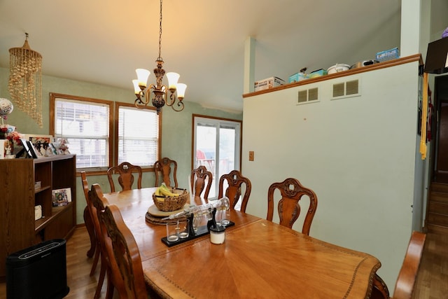 dining space with a notable chandelier and wood-type flooring