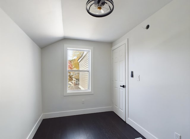 additional living space featuring dark hardwood / wood-style flooring and vaulted ceiling