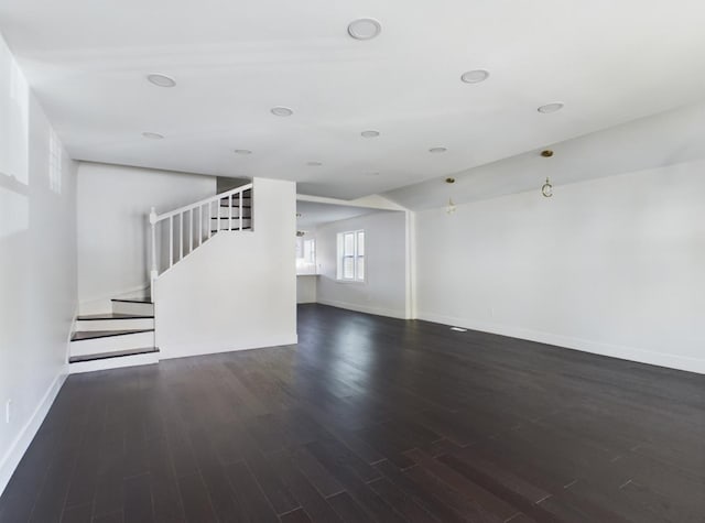 unfurnished living room with dark hardwood / wood-style floors