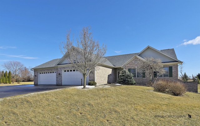 ranch-style home with an attached garage, driveway, and a front yard