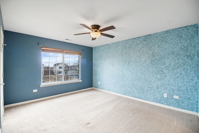 carpeted empty room featuring ceiling fan