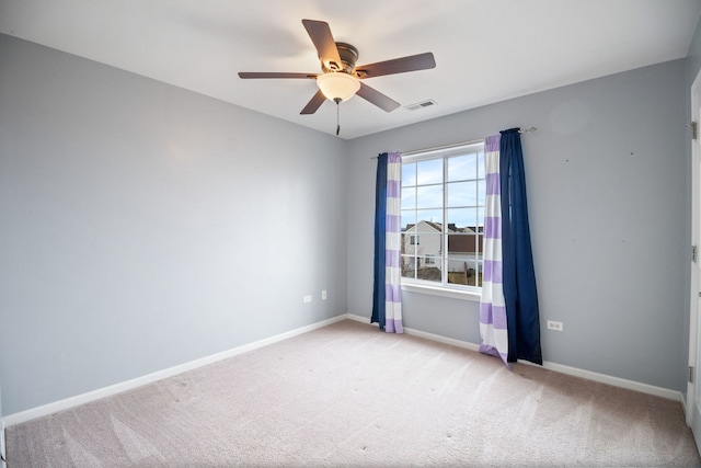 spare room with light carpet and ceiling fan