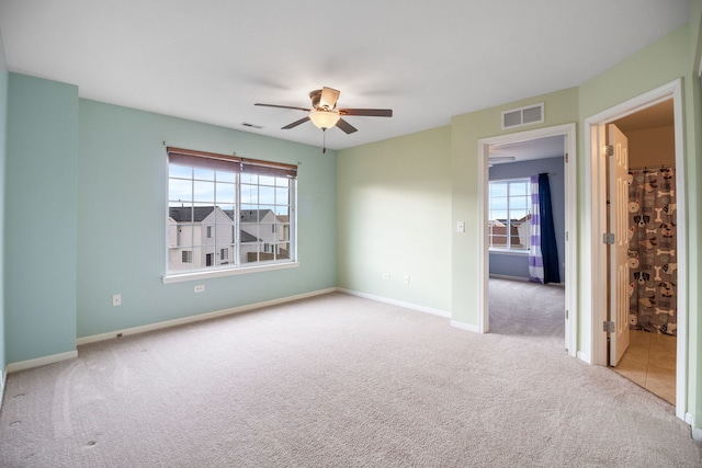 spare room with light carpet and ceiling fan