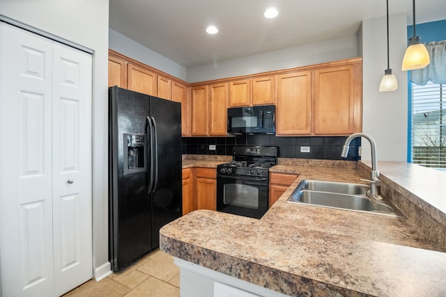 kitchen featuring black appliances, sink, backsplash, hanging light fixtures, and kitchen peninsula