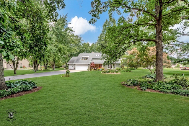 view of front of home featuring an attached garage, driveway, and a front yard