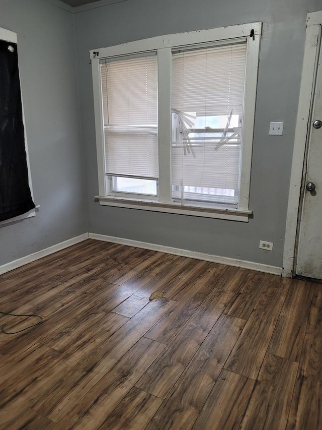 empty room with dark hardwood / wood-style flooring