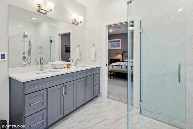 bathroom featuring a shower with door and vanity