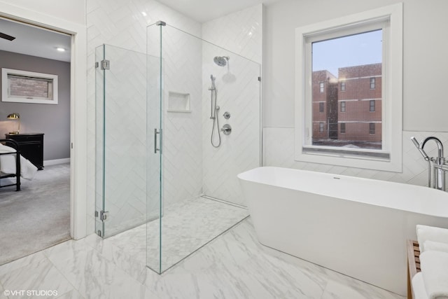 bathroom with independent shower and bath and tile walls