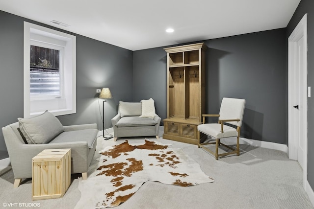 sitting room featuring light colored carpet