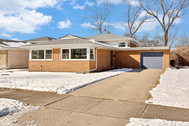 view of front facade featuring driveway, brick siding, and an attached garage