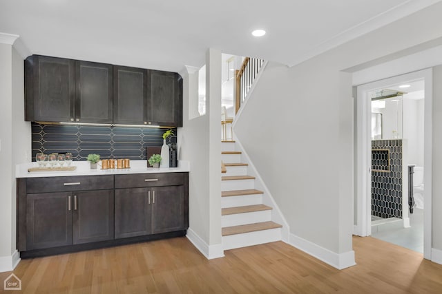 bar featuring tasteful backsplash, baseboards, stairway, light wood-style floors, and recessed lighting