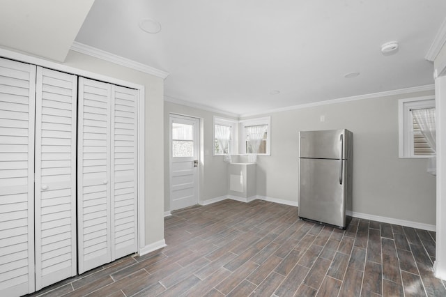 kitchen featuring stainless steel refrigerator and ornamental molding