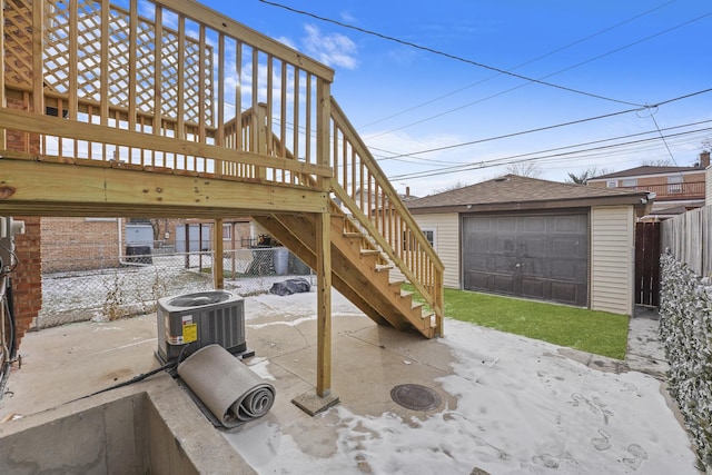 view of patio / terrace with a garage, an outbuilding, and central air condition unit