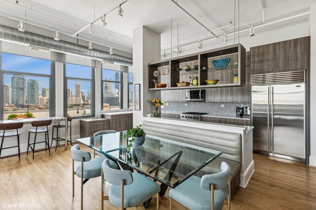 dining space featuring track lighting and light hardwood / wood-style floors