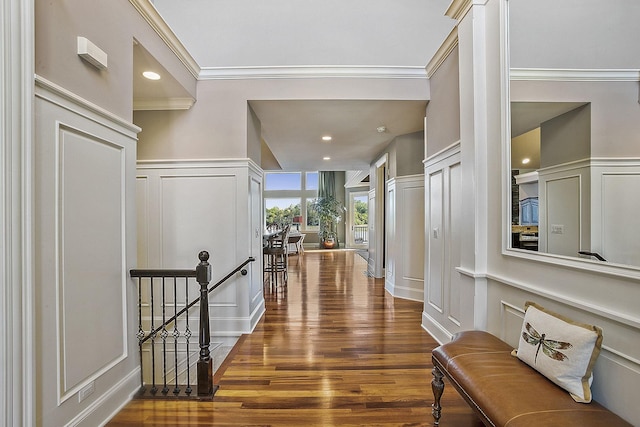 hall featuring hardwood / wood-style flooring and crown molding