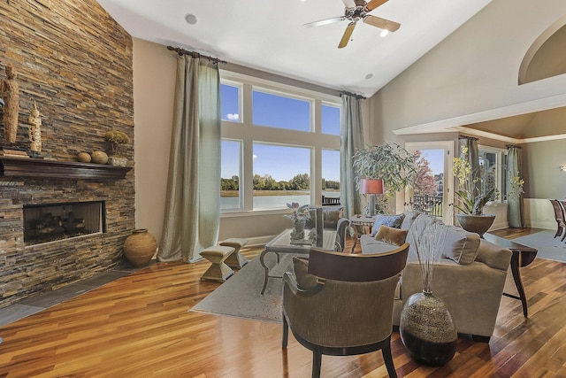 living area with ceiling fan, high vaulted ceiling, hardwood / wood-style floors, and a fireplace