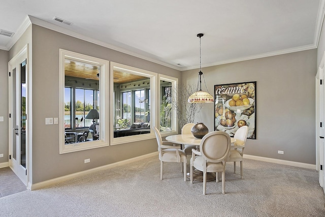 dining room with crown molding and light colored carpet