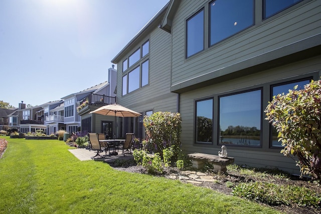 exterior space with a patio area and a lawn