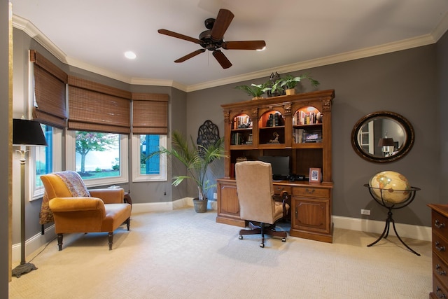 carpeted home office featuring ornamental molding and ceiling fan