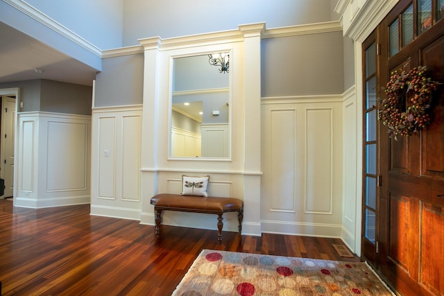 foyer entrance featuring decorative columns and dark hardwood / wood-style floors