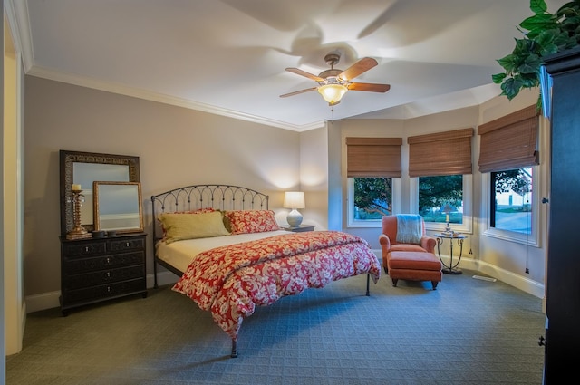 bedroom featuring ornamental molding, ceiling fan, and dark colored carpet