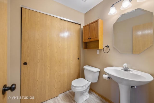 bathroom featuring hardwood / wood-style floors and toilet