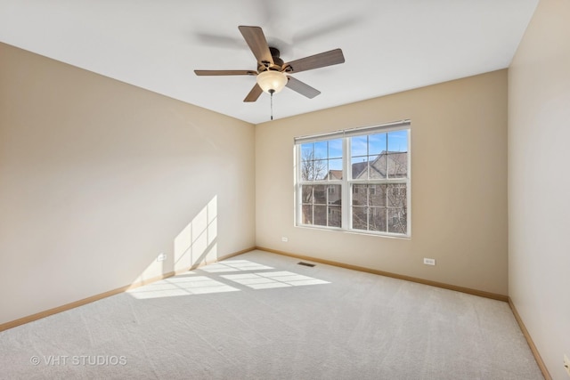 carpeted spare room with ceiling fan