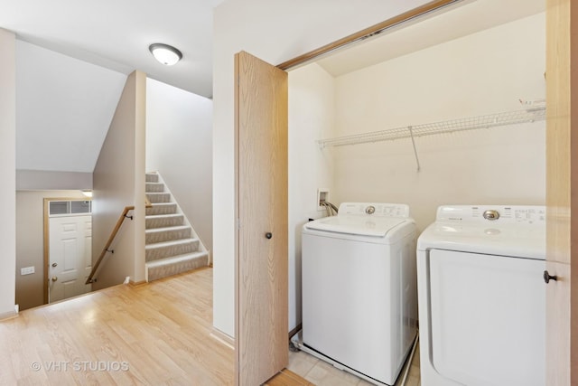 washroom featuring washer and clothes dryer and light wood-type flooring