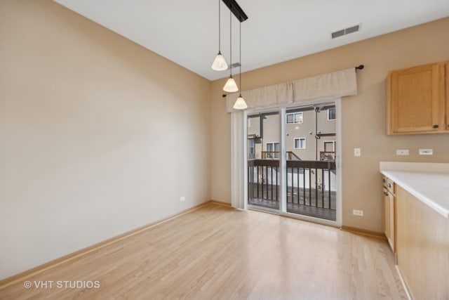 unfurnished dining area featuring light hardwood / wood-style flooring