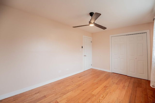 unfurnished bedroom with ceiling fan, light hardwood / wood-style floors, and a closet