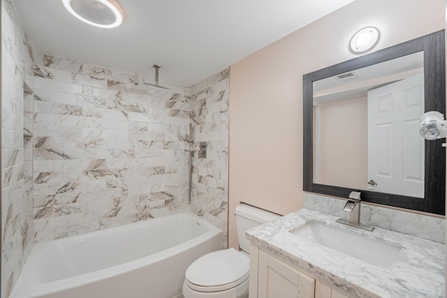 full bathroom featuring tiled shower / bath combo, vanity, and toilet