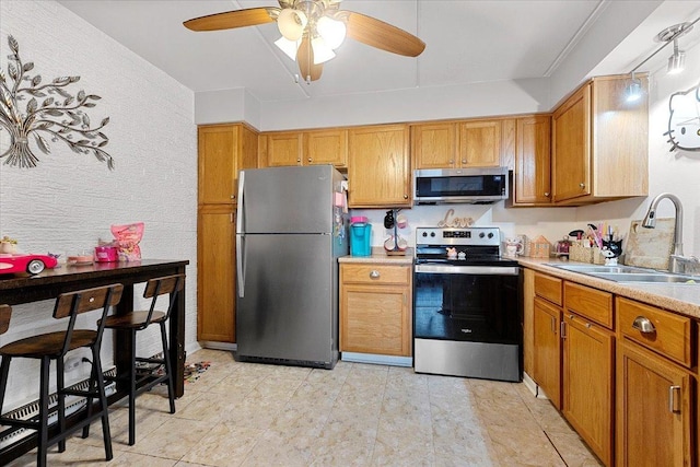 kitchen featuring ceiling fan, appliances with stainless steel finishes, and sink