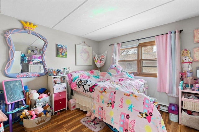 bedroom featuring a baseboard heating unit and dark wood-type flooring