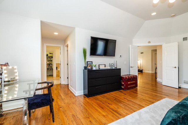 bedroom with lofted ceiling and light hardwood / wood-style floors