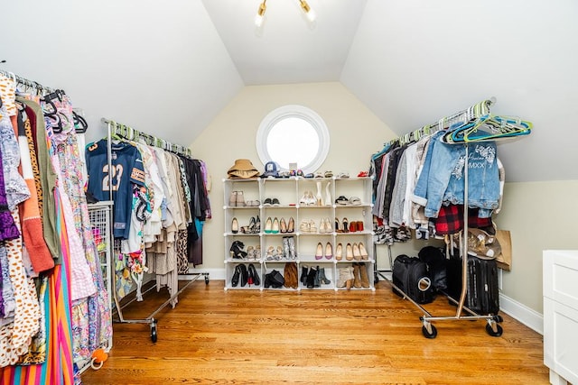 spacious closet with lofted ceiling and hardwood / wood-style floors