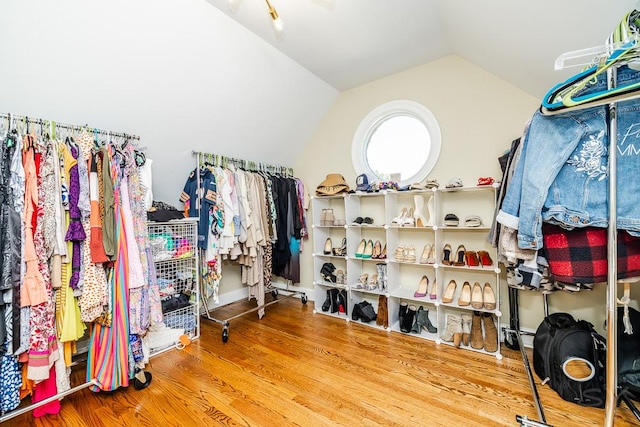 spacious closet with hardwood / wood-style flooring and vaulted ceiling