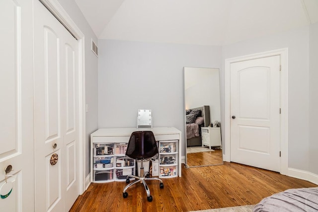 home office with hardwood / wood-style floors