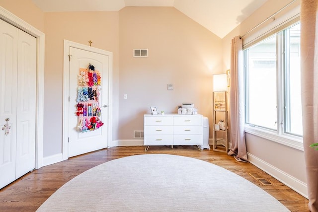 bedroom featuring hardwood / wood-style floors and vaulted ceiling