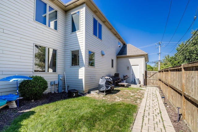 rear view of property featuring a lawn