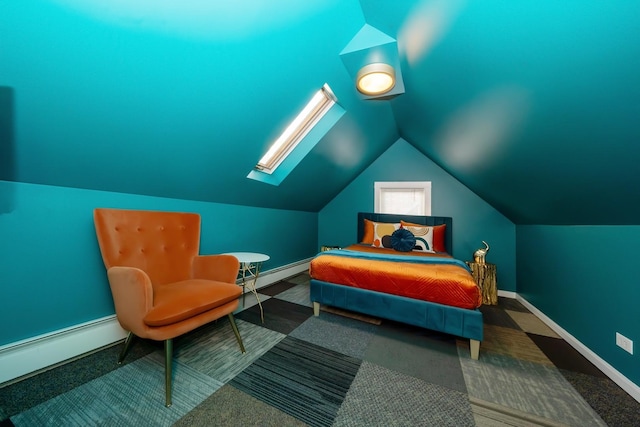 bedroom with vaulted ceiling and a baseboard heating unit