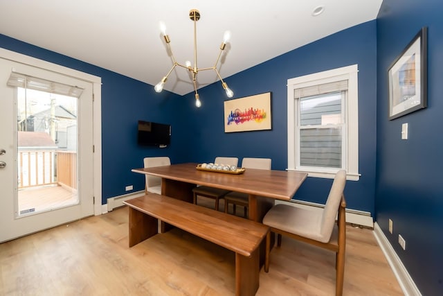 dining space with a baseboard radiator, plenty of natural light, a chandelier, and light hardwood / wood-style flooring