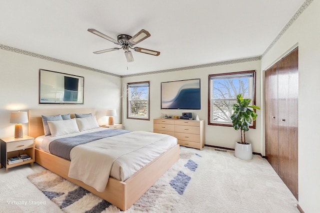 bedroom with multiple windows, ornamental molding, and light colored carpet