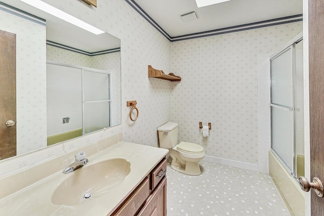 full bathroom with crown molding, enclosed tub / shower combo, vanity, and toilet