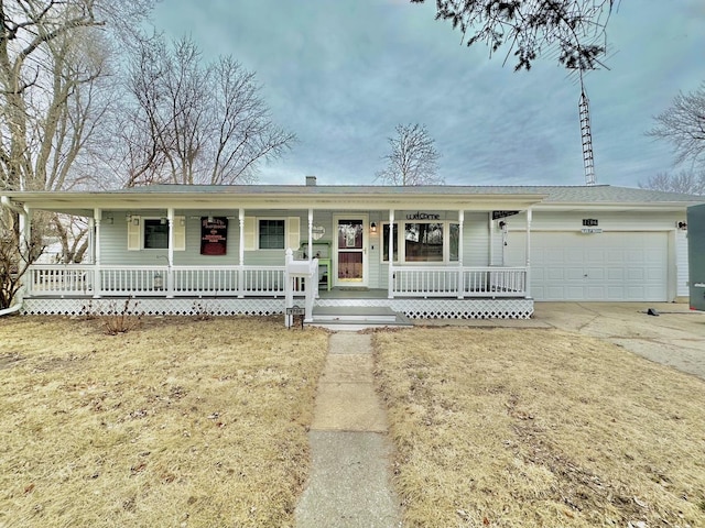 ranch-style home with a garage, a porch, and a front yard