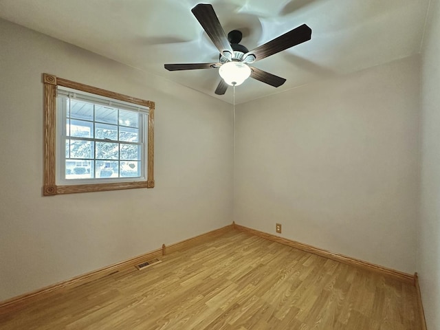 empty room featuring ceiling fan and light hardwood / wood-style flooring