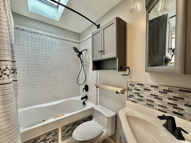 full bathroom featuring sink, backsplash, a skylight, toilet, and shower / bath combo with shower curtain