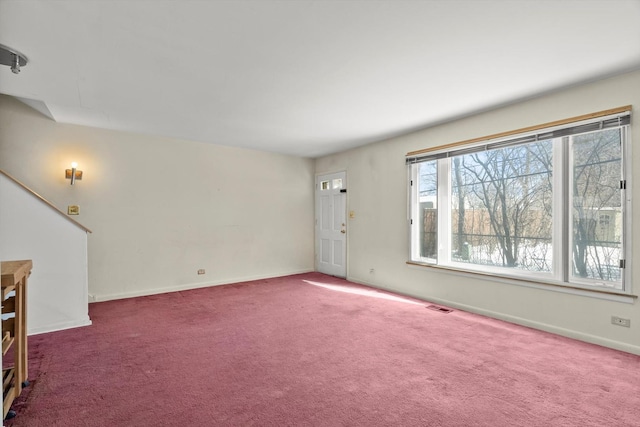 unfurnished living room featuring dark colored carpet