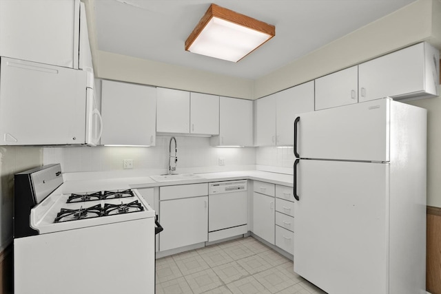 kitchen with white appliances, sink, white cabinets, and tasteful backsplash